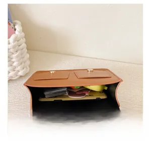 Detail view of brown PU leather bag interior storage space for smartphones and accessories