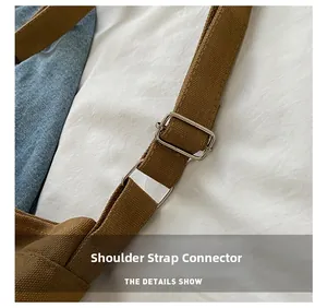 Close-up of brown canvas shoulder strap with silver metal buckle on a kids bag