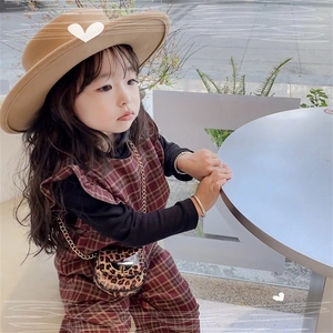 Chic leopard print crossbody saddle bag with metal chain styled on a toddler girl outfit