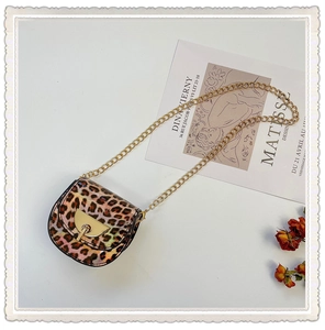 Detail of pink leopard print saddle bag for girls with gold chain and matte PU leather
