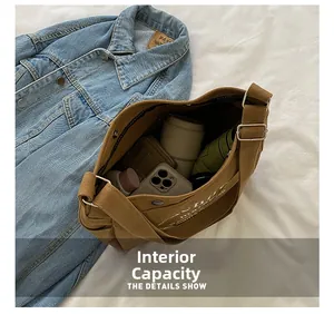 Detail showing the large interior capacity of this brown canvas kids crossbody bag