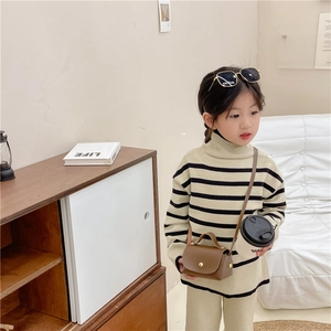 Child fashion coffee leather crossbody bag styled with a beige striped knit outfit