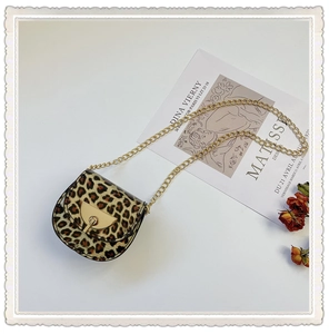 Detail view of mini leopard print saddle bag for girls with gold chain strap and metal lock