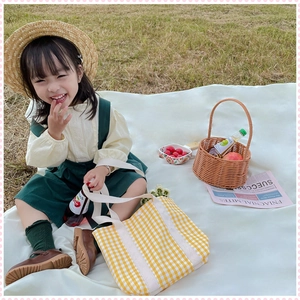 Detail of yellow gingham canvas tote bag for girls featuring durable woven handles