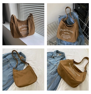 Detail of caramel canvas messenger bag with adjustable strap and side pocket
