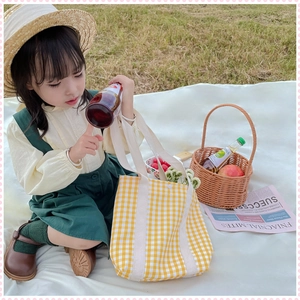 Close-up of yellow checkered canvas tote bag with thick handles for young girls