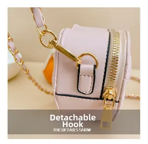 Detail of detachable gold metal hook and zipper on pink mini chain bag for girls