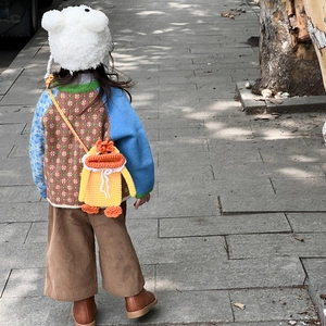 Handmade knitted duck crossbody bag for kids styled with a retro autumn outfit