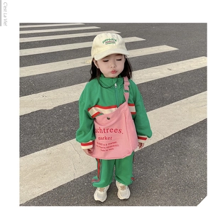 Detail view of green vintage kids tracksuit with striped ribbed cuffs and embroidery