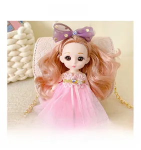 Detail of doll crossbody bag featuring pink lace dress and elegant pearl handle