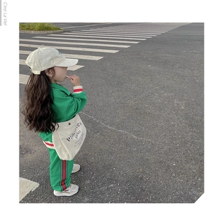 Kids green sports tracksuit featuring side stripes and classic zip-up stand collar