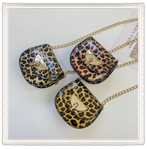 Three leopard print mini saddle bags in various colors with gold chain straps for girls