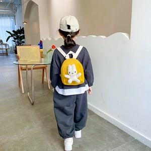 Kids yellow canvas backpack with miffy rabbit plush toy shown from the back perspective