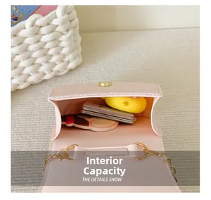 Detail showing the internal capacity and magnetic closure of the pink mini crossbody bag