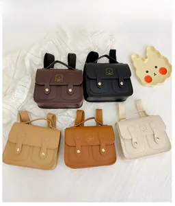 Flat lay of colorful mini PU leather children backpacks with gold bear prints
