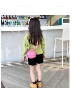Detailed view of pink mini handbag for girls with gold buckle and adjustable strap