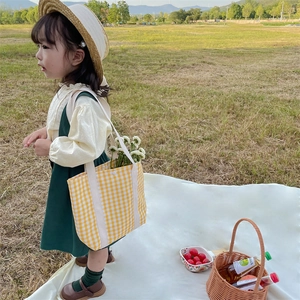 Kids yellow plaid canvas tote bag paired with a vintage green pinafore dress and straw hat