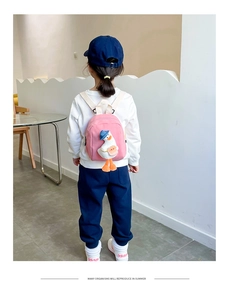 Detailed back view of pink kids canvas backpack with a 3D plush duck decoration