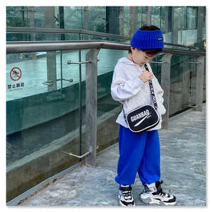Fashionable black crossbody bag for kids featuring white sporty lettering and zipper