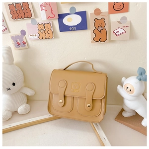 Detail of khaki PU leather kids backpack with cute bear embroidery and double-button closure