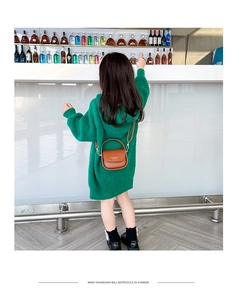 Detailed back view of girls green knitted hooded dress with a brown leather crossbody bag