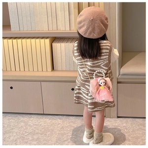 Detail of pink toddler handbag with plush doll decoration and pearl handle strap