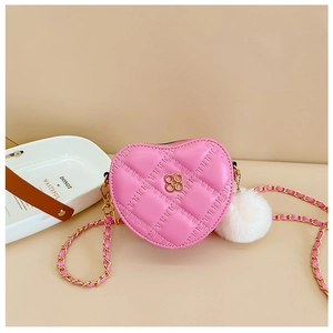 Detailed view of pink quilted heart bag with gold flower clasp and white pompom charm