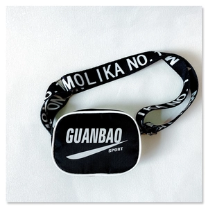 Close-up of durable black nylon crossbody bag with white sport logo and lettered strap