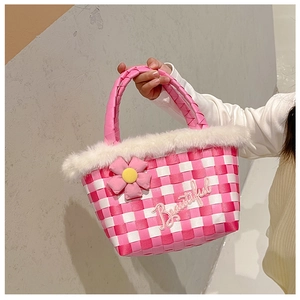 Detailed close-up of girls' pink checkered woven handbag with white faux fur and flower