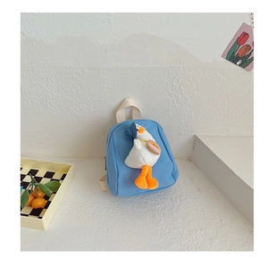 Detail of blue canvas kids backpack with a 3D plush duck and checkerboard decor