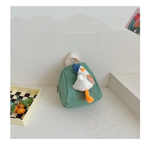 Detailed shot of kids canvas mini backpack with cute 3D plush duck in morandi green