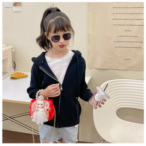 Kid fashion crossbody bag with doll decor, pearl chain strap, and red finish on model