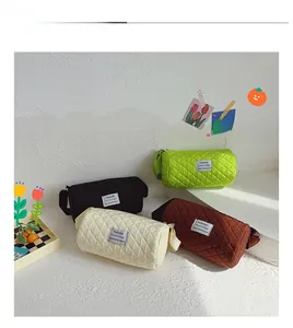 Quilted cylindrical crossbody bags for kids shown in black, green, beige, and brown colors
