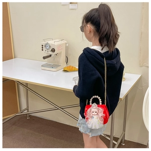 Mini red crossbody bag for girls with cute doll ornament and elegant pearl handle