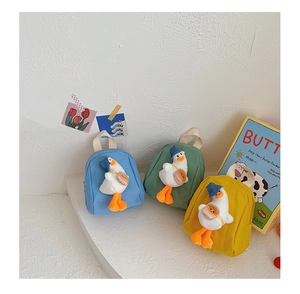 Detailed view of colorful canvas mini backpacks featuring 3D plush duck decorations