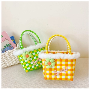 Detail of woven kids handbag with plush fur trim and 3D floral embroidery decoration