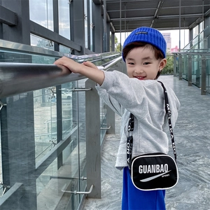 Kid's black fashion crossbody bag with white letters and adjustable graphic shoulder strap