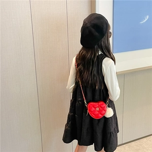 Girl's red heart-shaped quilted crossbody bag with chain strap and fluffy white charm