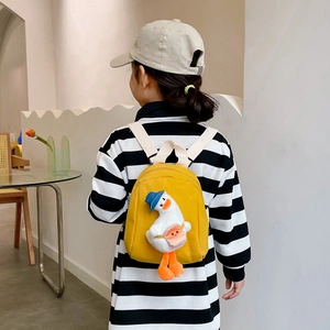 Cute yellow canvas backpack for toddlers featuring a 3D duck doll and soft straps