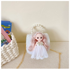Detail of white lace kids handbag with pearl handle and pink hair doll decoration