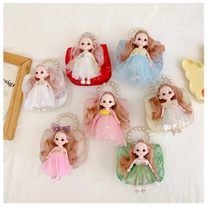 Flat lay of colorful mini princess handbags with pearl handles and doll decorations