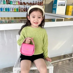 Pink mini faux leather handbag for girls with gold lettering and top handle design