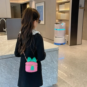 Pink quilted mini crossbody bag for girls with green bow decoration and chain strap