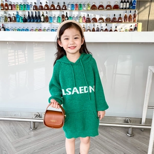 Green knitted hooded dress for girls with white lettering and a vintage brown handbag