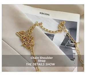 Macro shot of gold rectangular chain strap and polished metal links on texture