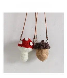 Detail of handmade crochet mushroom and acorn bags for kids with crossbody straps