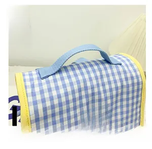 Detail of blue and white checkered canvas bag with yellow piping and durable blue handle