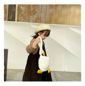 Close-up of handmade crochet white goose handbag for girls with textured stitch detail