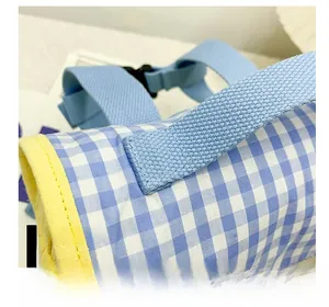 Detailed close-up of blue and white checkered canvas backpack showing sturdy stitching