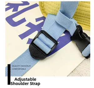 Detail view of yellow woven fabric backpack with adjustable blue nylon straps and plastic buckle